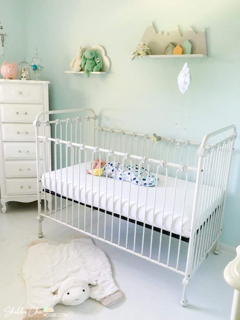 Gender Neutral Baby Room, White Crib with Baby in it and could/mountain shaped book shelves