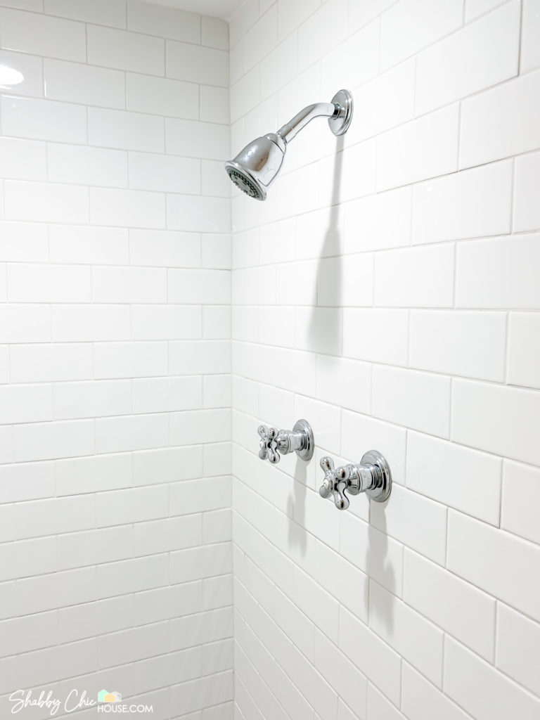 White Subway Tile Shower and Vintage looking chrome shower handles