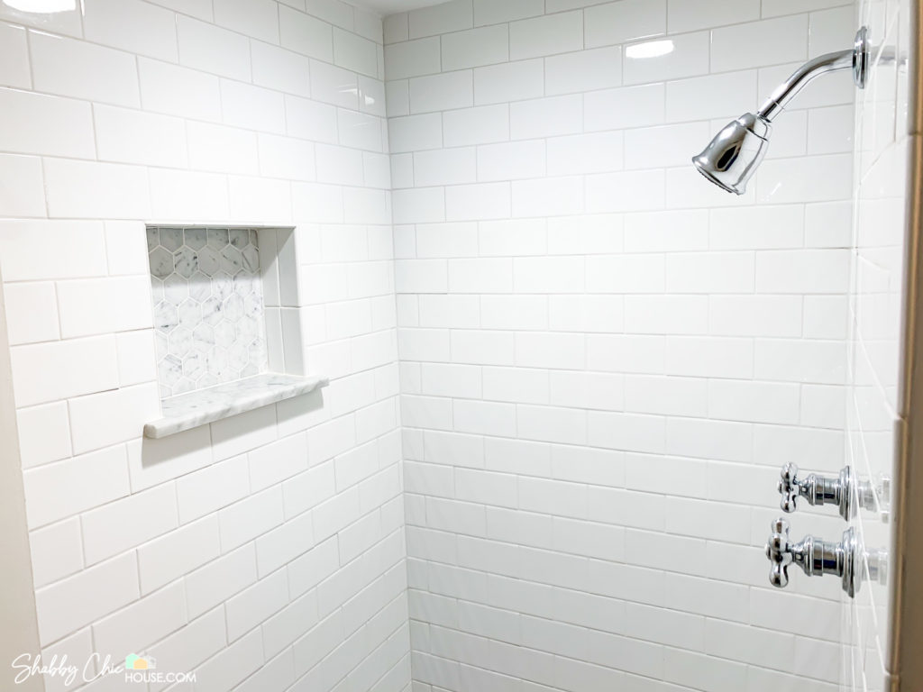 White Subway Tile with Italian Carrara Show Niche and Vintage Shower Handles