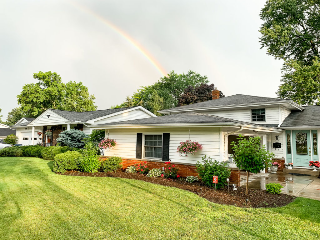 Exterior of the Shabby Chic House with Rainbow and Flowers