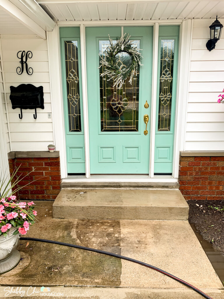 front door and step in which half has been power washed and half is dirty showing the power of cleaning to boost curb appeal
