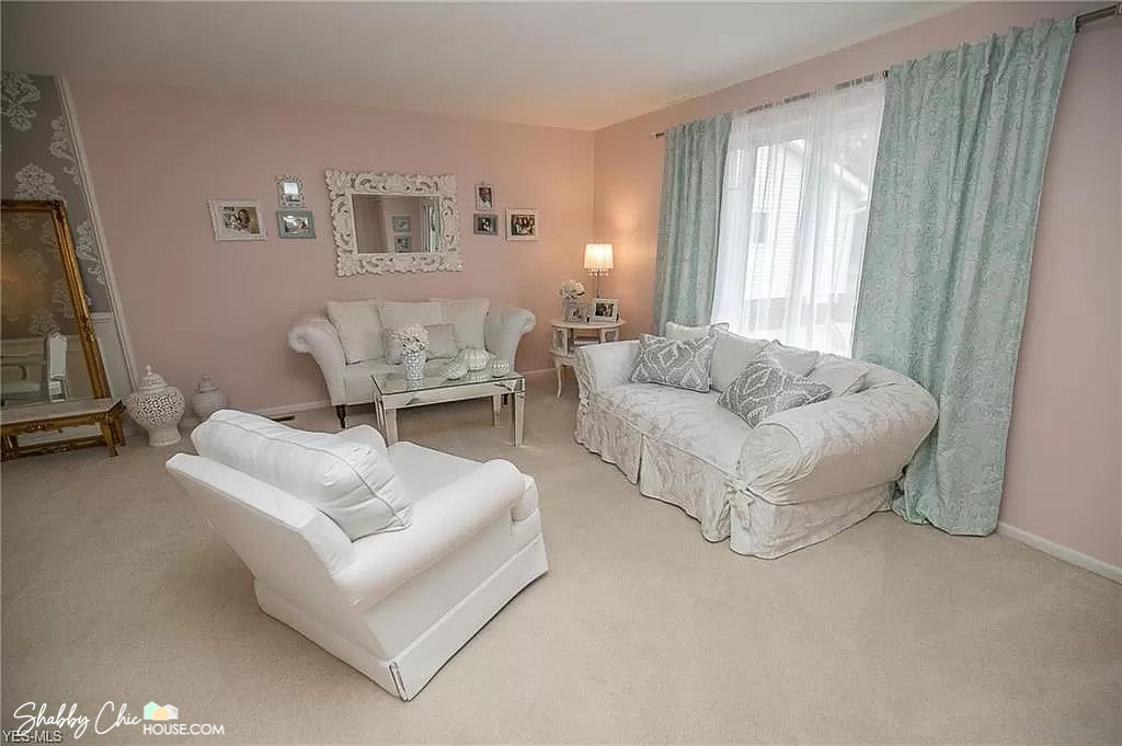 Pink living room prior to being painted white and being decluttered to help sell house