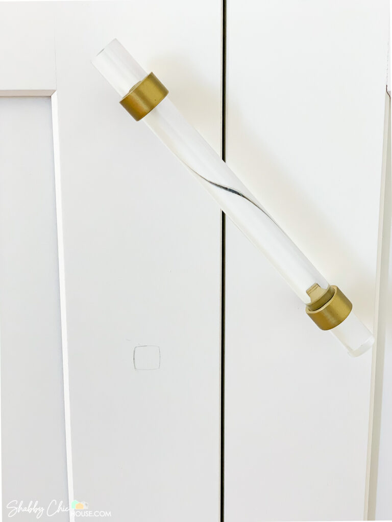 mark showing where to drill holes for installing cabinet handles