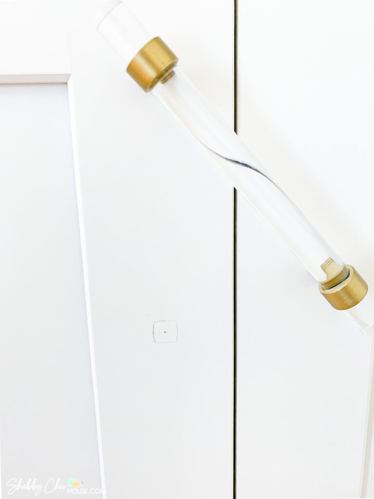 center mark showing where to drill holes for installing cabinet handles