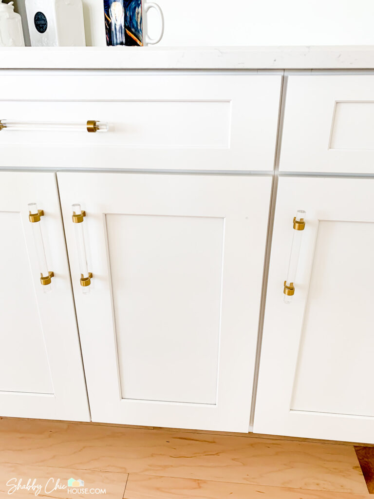 cabinet hole after wood filler and touch up paint from a distance