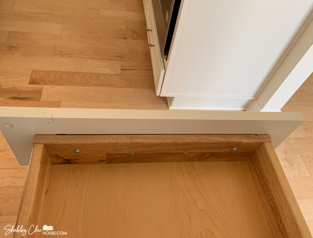 How to install cabinet hardware - interior shot of cabinet drawer - drilling through drawer and faceplate