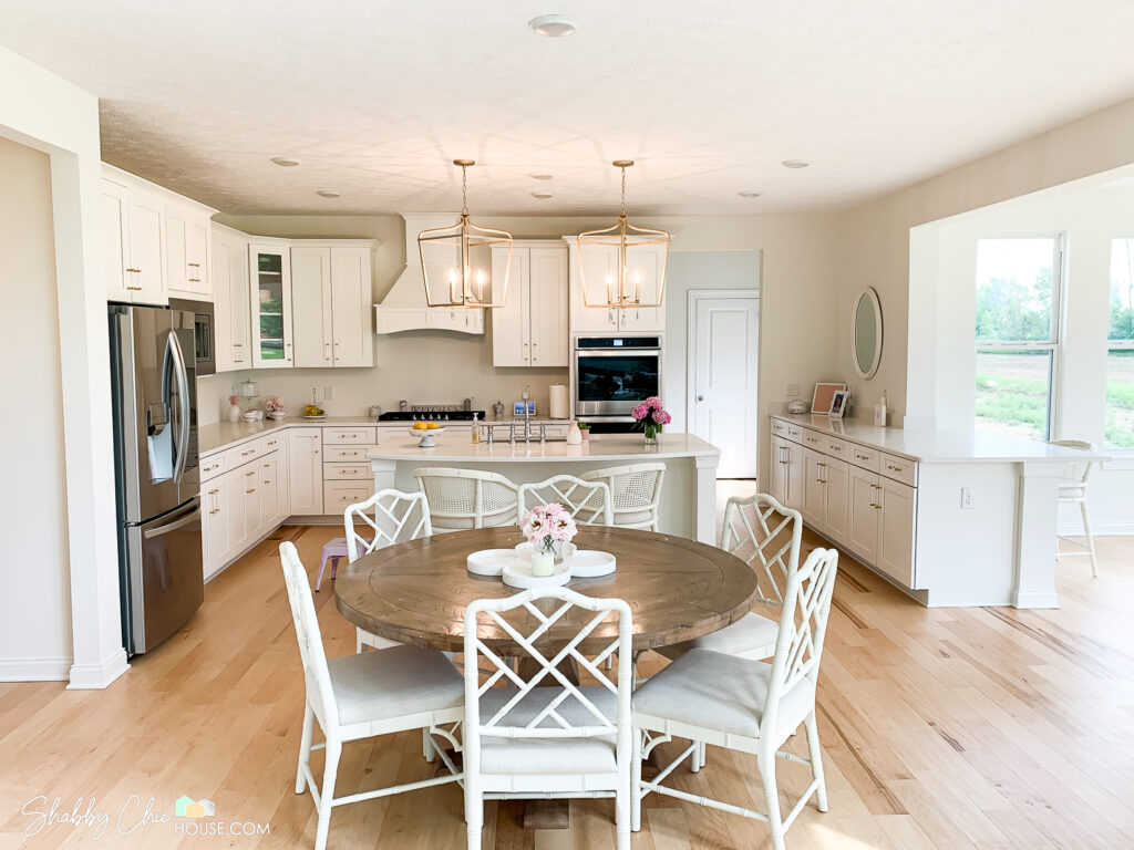 Kitchen with White Shaker Cabinets, Quartz Countertop Island, Minka Lavery Pendant lights and Ballard Designs Dana & Anna Chairs