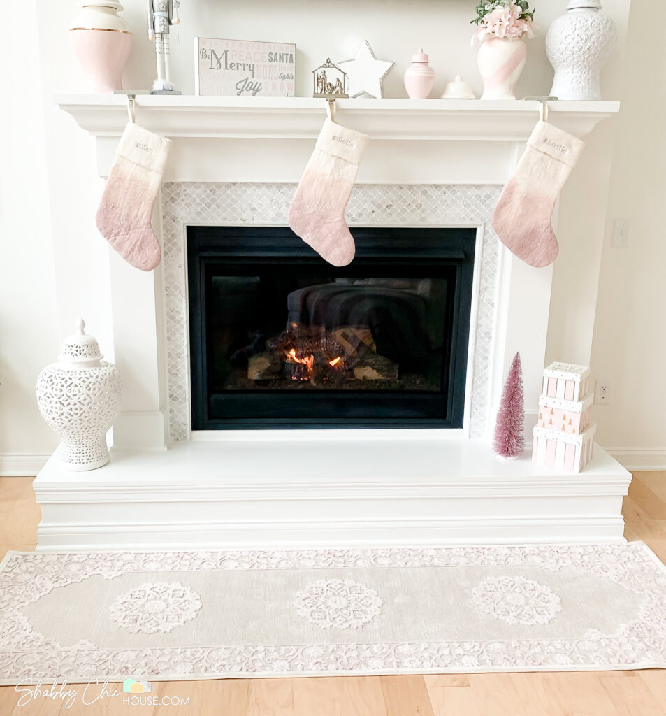 White Fireplace with Italian Carrara Marble Tile Surround Vases, Christmas Stocking on the mantle