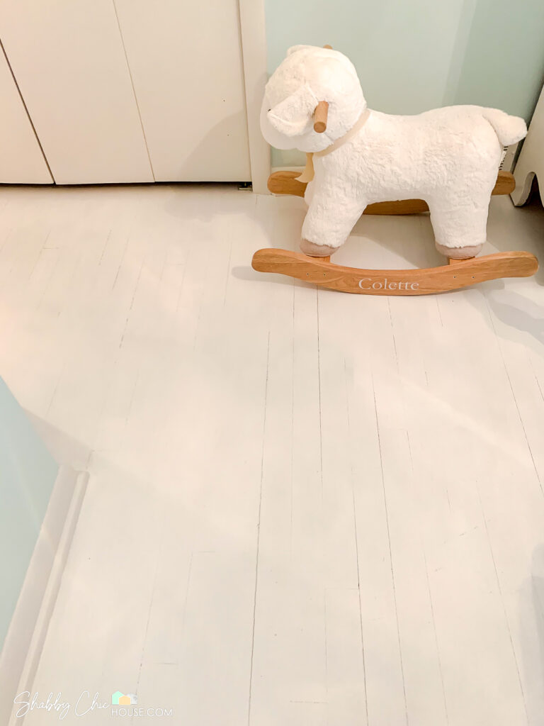 Close-up of hardwood floors painted white