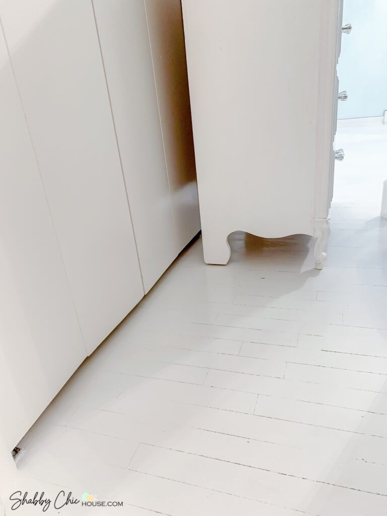 White hardwood floor and white dresser
