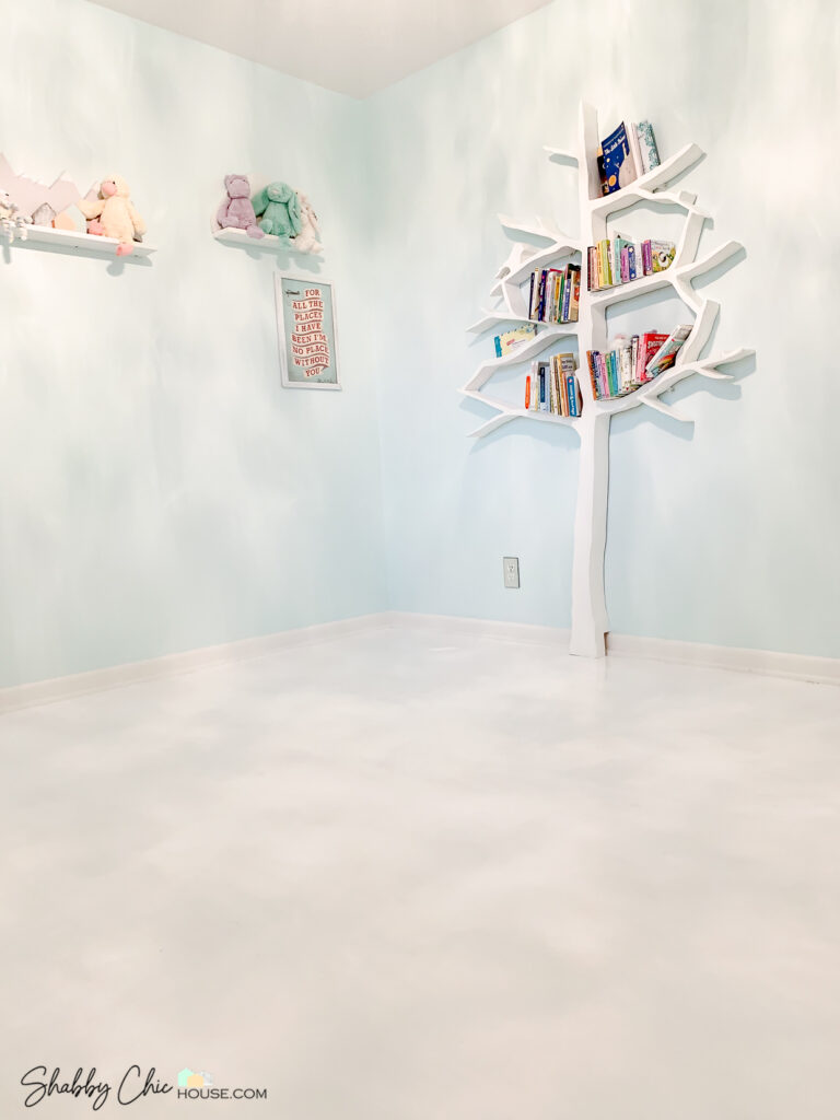 White Hardwood Floors in green kid's room with tree shaped book shelf on wall