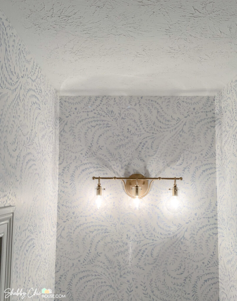 How to Hang Wallpaper - final photo of the ceiling and fixture before crown moulding has been added.