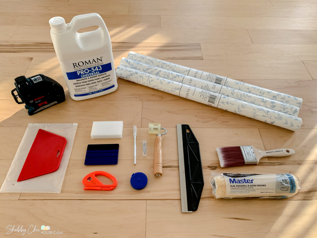 All the tools you need to hang wallpaper - 3 rolls of wallpaper, wallpaper adhesive, Bosch laser level, straight edge, seam roller, smoothing tool, razor blades & more