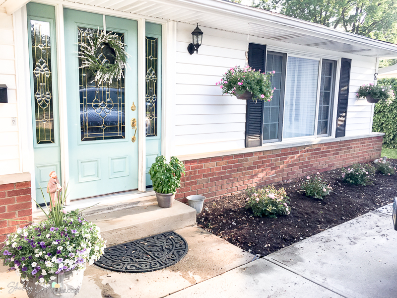 photo of a house right after the landscaping has been upgraded for an article on boosting your curb appeal and selling your house.