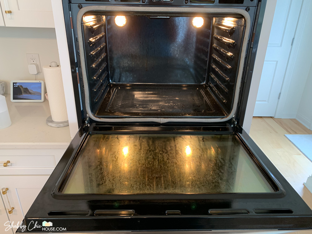 Gross and greasy oven before cleaning hack with The Pink Stuff & Scrub Daddy.