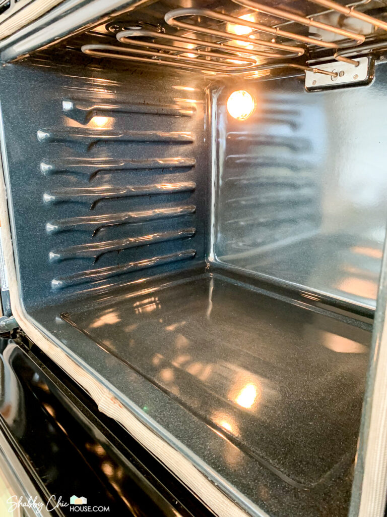 Angled shot of the inside of the oven after cleaning hack with The Pink Stuff and a Scrub Daddy.