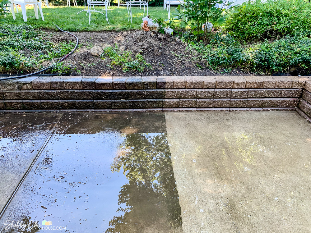 Half of a Patio and brick retaining wall power washed showed the huge impact power washing each Spring can make