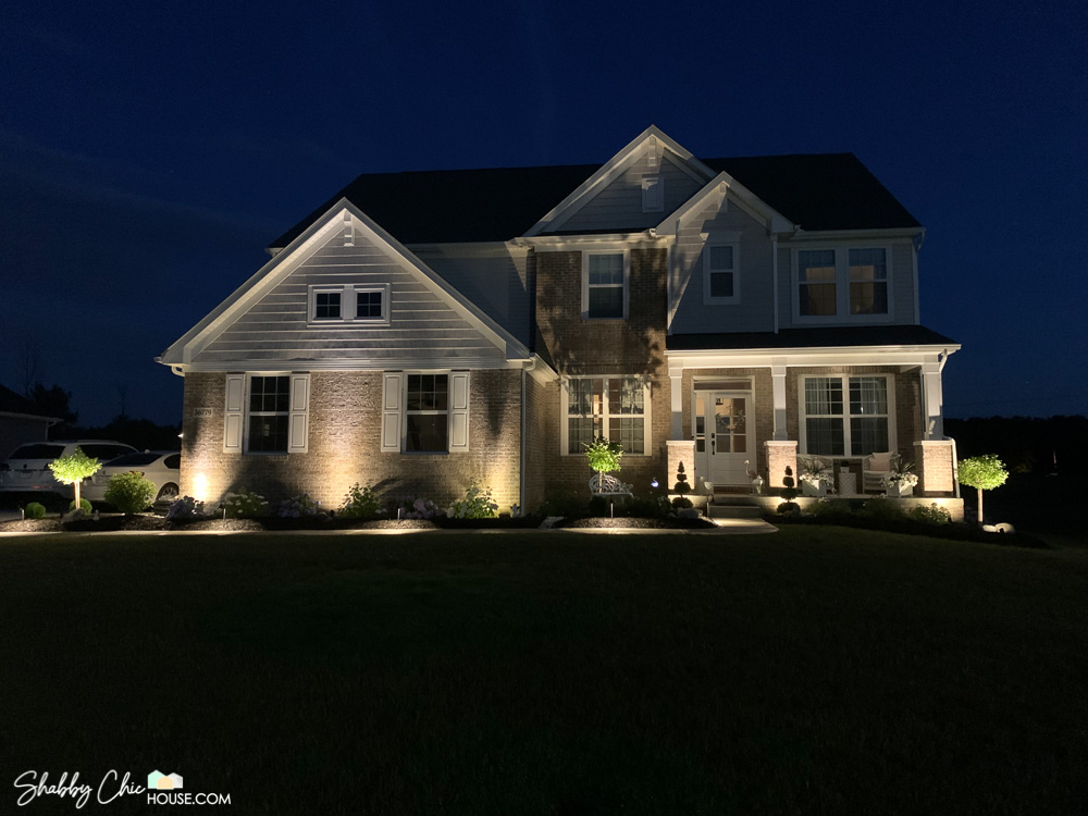 image of a house with DIY landscape lighting and uplighting as well as pathway lights