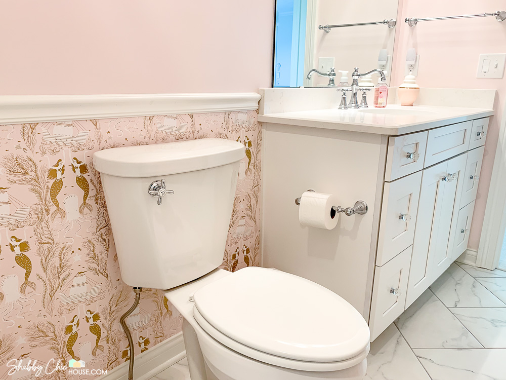 chair rail height placement in a small pink bathroom.