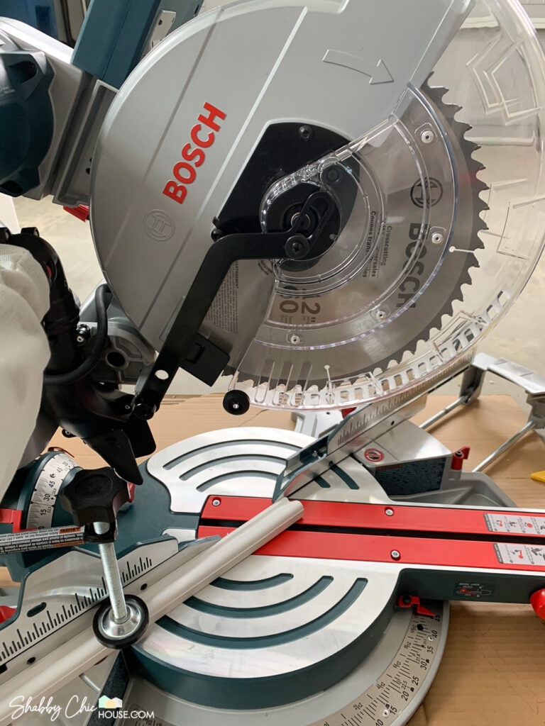How to Cut Wainscoting - Close up of me cutting a 45 degree miter with a Bosch Dual-Bevel Sliding Glide Miter Saw.