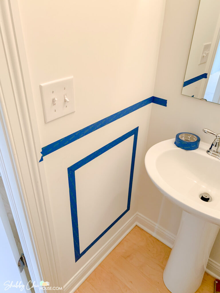 wainscoting layout tips - using blue painter's tape to help plan out and visualize wainscoting boxes