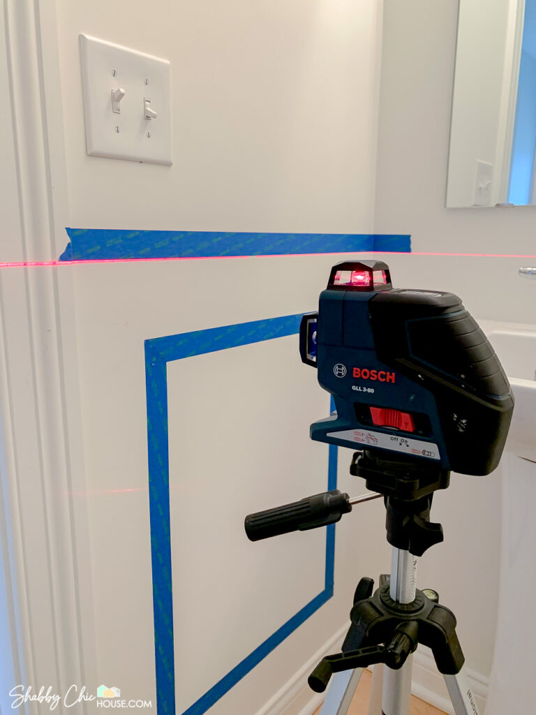wainscoting layout tips - using blue painter's tape along with a laser level to help plan out and visualize wainscoting boxes