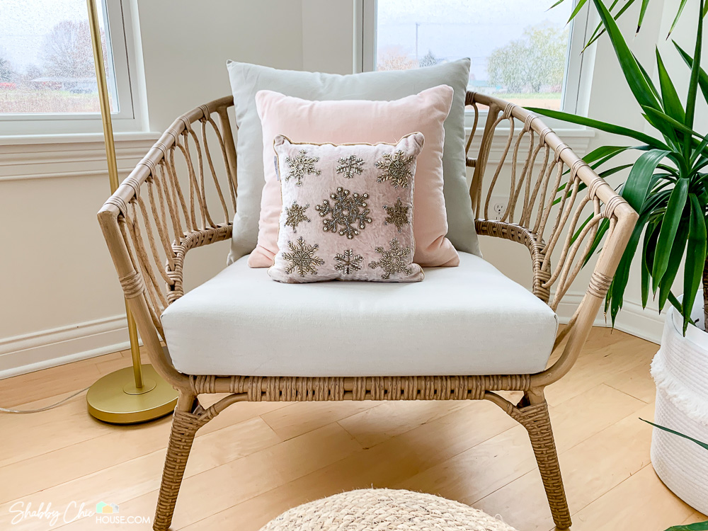 Ratan chair with beaded snowflake pillow for a blog post on 2022 holiday decor.