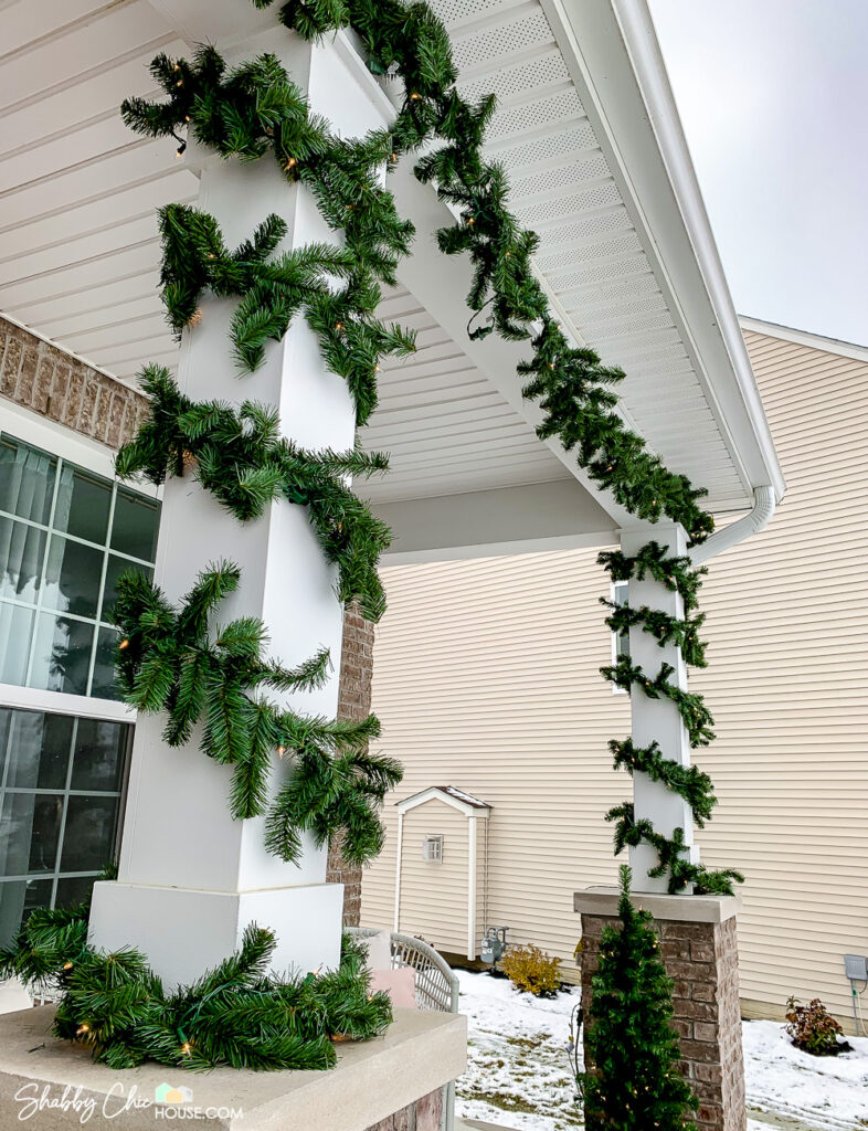 18' pre-lit garland from Home Accents shown draped and wrapped around front porch pillars.