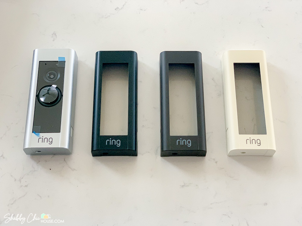 Image of the Ring Doorbell Pro and it's four different colored vanity covers which include silver, black, chocolate brown and a cream white.