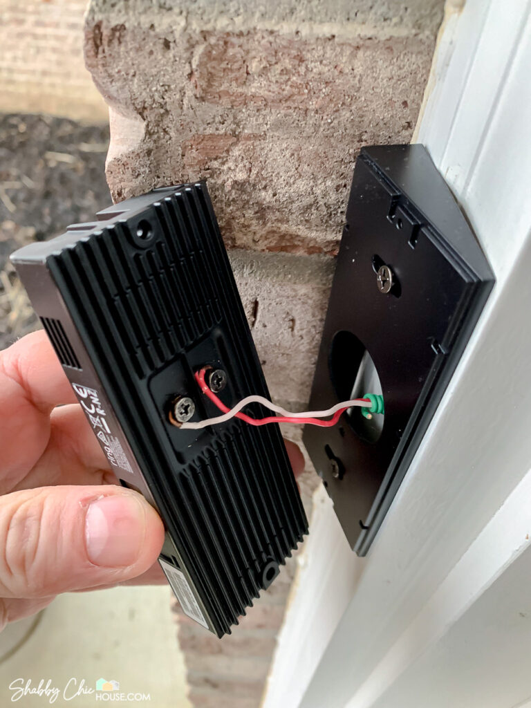 Image of the Ring Doorbell pro being installed and hardwired as well as use of a wedge to get the best angle for the camera.