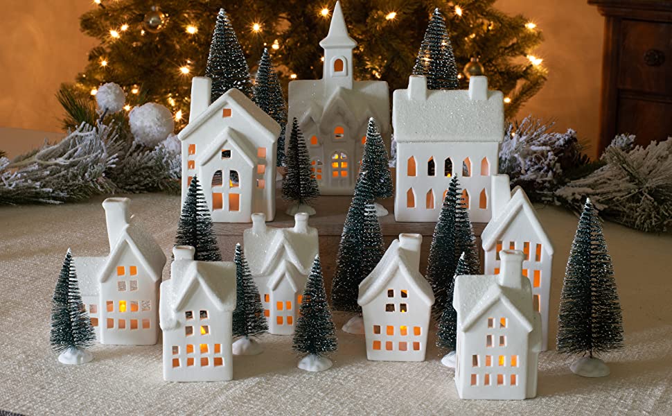 Image of a 31 piece white porcelain winter village with sisal trees and LED candle lights for a blog post on the top Christmas decoration ideas.