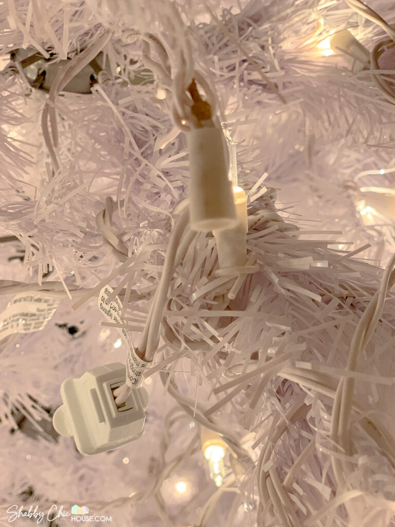 Close up shot of a Christmas tree light bulb socket that has been broken and the wiring has come loose for a blog post on how to fix broken Christmas tree lights.