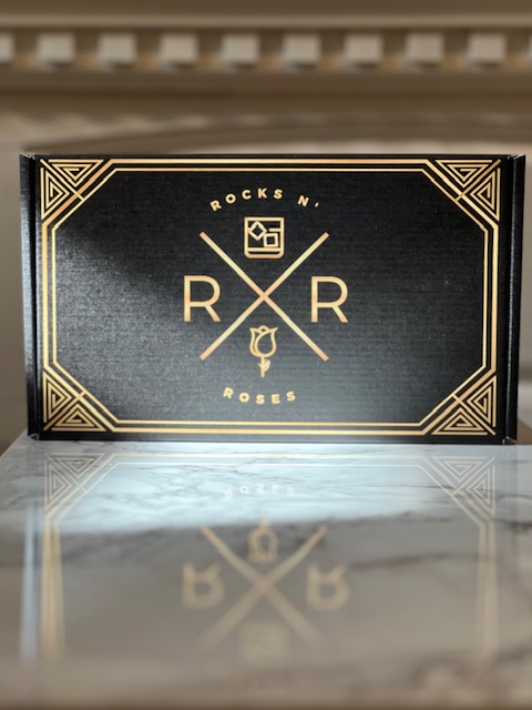 The Rocks N' Roses Bourbon(less) box. An image of the outside of the black and gold box.