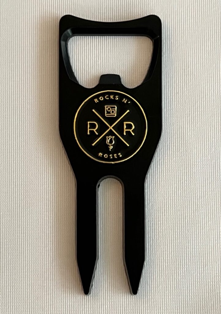 The Rocks N' Roses 4-in-1 multi-tool divot tool includes a divot repair tool, ball marker, bottle opener as well as club rest for the dew